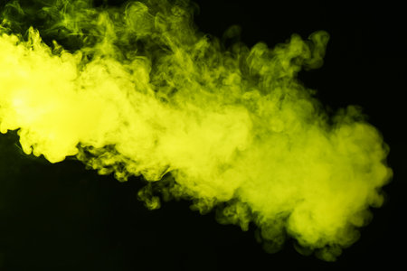 Hookah smoke in yellow light on black background, closeupの写真素材
