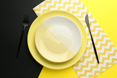 Stylish plates, cutlery and napkin on color background, flat layの写真素材