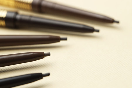 Automatic eyebrow pencils on beige background, closeupの写真素材