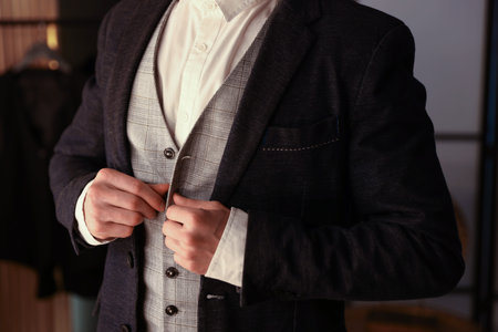 Man in stylish outfit getting ready indoors, closeup