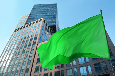 Bright green flag waving against building outdoorsの写真素材