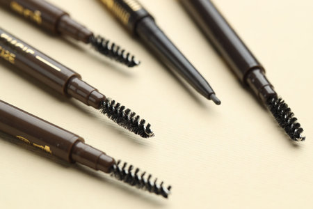 Automatic eyebrow pencils on beige background, closeupの写真素材