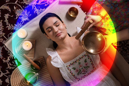 Woman meditating during singing bowl therapy, top view. Rainbow bubble around her representing auraの写真素材