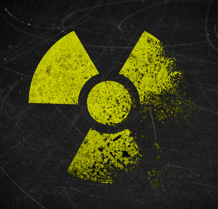Yellow radioactive sign on scratched black surface. Radiological pollutionの写真素材