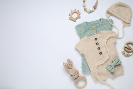 Baby clothes and accessories on white background, flat lay. Space for textの写真素材