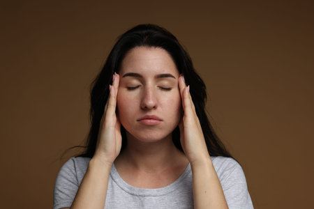 Panic attack. Woman calm herself down on brown background