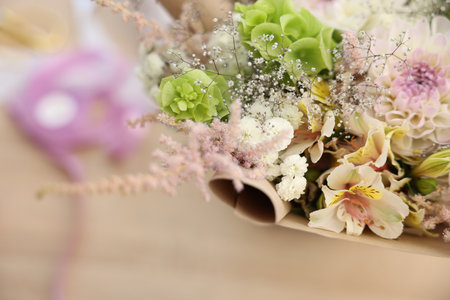 Beautiful bouquet of flowers on table in shop, closeupの写真素材