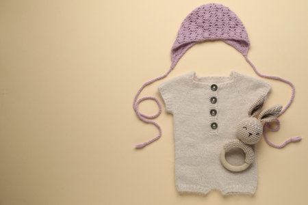 Baby clothes and accessory on beige background, flat lay. Space for textの写真素材
