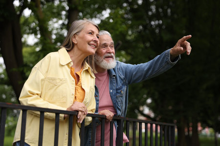 Lovely senior couple walking together in park, low angle view