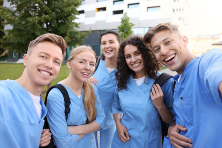 Group of medical students taking selfie outdoors