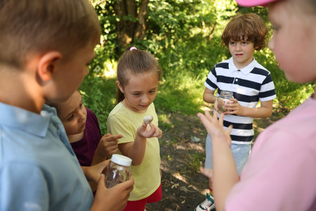 Children with snail and jars in natureの写真素材
