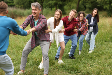 Team building. Group of happy people holding hands outdoorsの写真素材