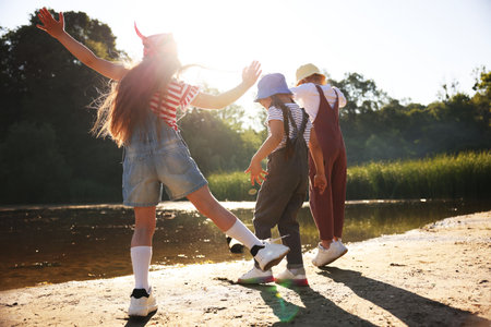 Cute little girls spending time in nature on sunny day