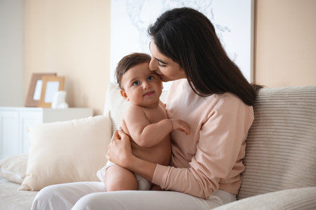 Happy mother with her cute little baby at homeの写真素材