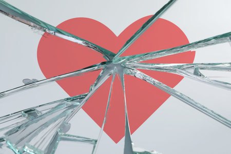 Broken glass with red heart, closeup