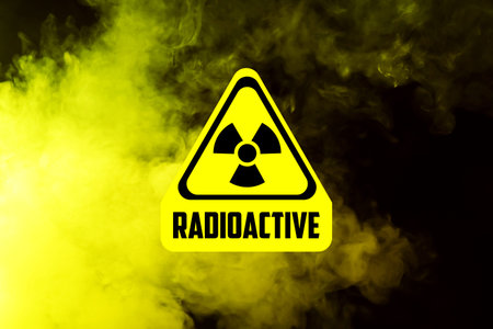 Yellow sign and yellow smoke against black background