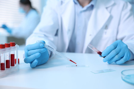 Medical analysis. Scientist working with blood sample in laboratory, selective focus
