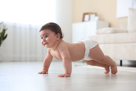 Cute little baby crawling on floor at home