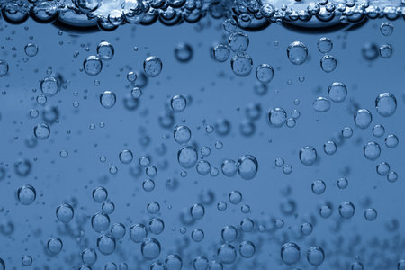 Soda water with bubbles of gas in glass, closeup