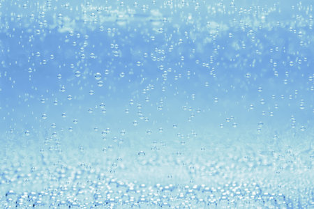Soda water with bubbles of gas in glass, closeup
