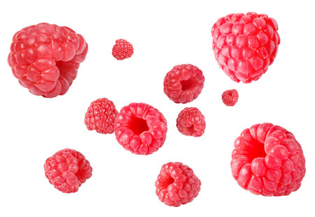 Fresh raspberries swirling in air against white background
