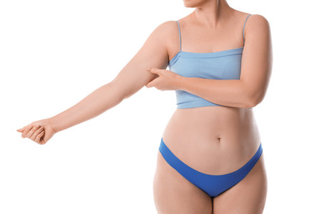 Woman with flabby arm on white background, closeupの写真素材