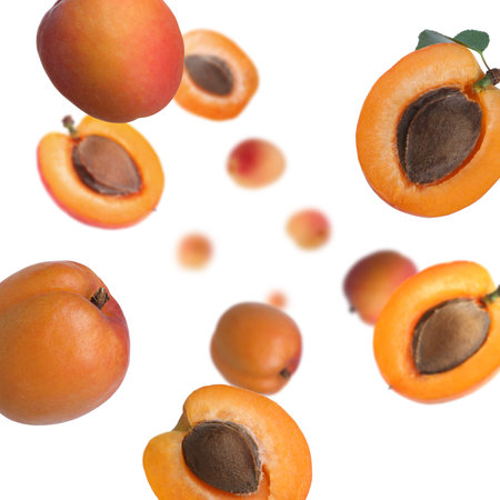Fresh apricots swirling in air against white backgroundの写真素材