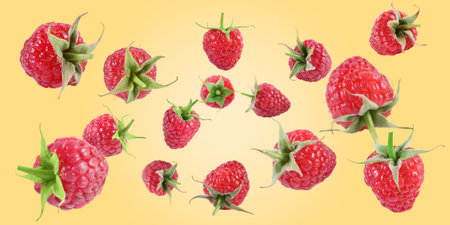 Fresh raspberries swirling in air against pale orange background