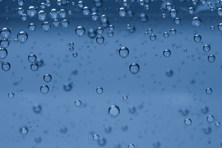 Soda water with bubbles of gas in glass, closeup