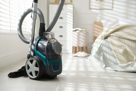 One vacuum cleaner on floor in bedroom. Space for textの写真素材