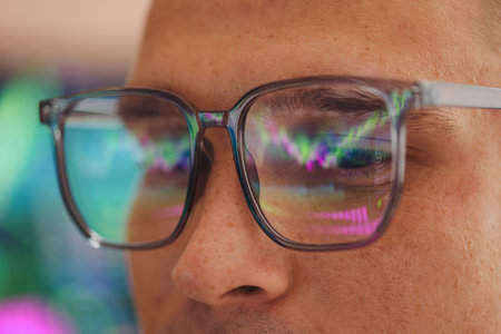 Young man wearing glasses with reflection on blurred background, closeupの写真素材