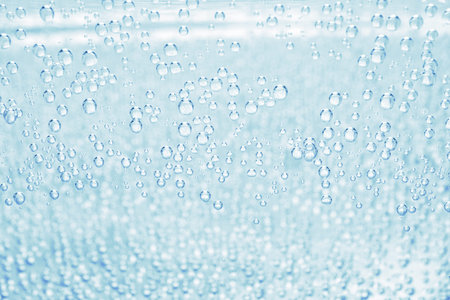 Soda water with bubbles of gas in glass, closeup