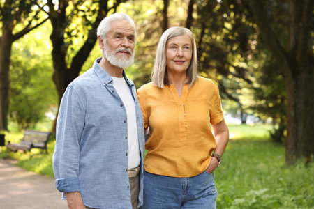 Lovely senior couple walking together in parkの写真素材