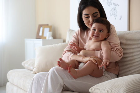 Happy mother with her cute little baby at home, space for textの写真素材