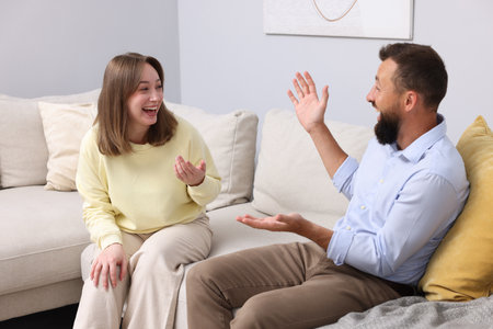 Friends laughing on sofa at home. Positive emotionの写真素材