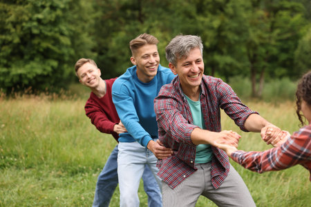 Team building. Group of happy people holding hands outdoors