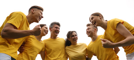 Team building. Group of happy people together outdoors, low angle view