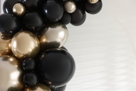 Stylish photo zone with balloons and decor in studio, closeup. Space for text