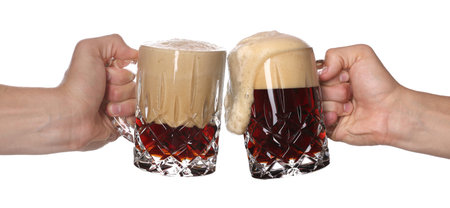 Men clinking their glasses of beer together against white background
