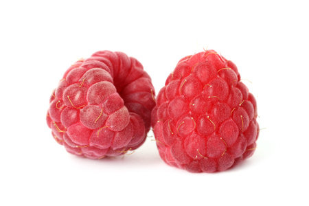 Two fresh ripe raspberries isolated on white