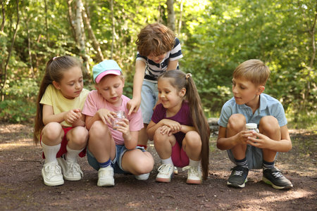 Group of children with jars in nature