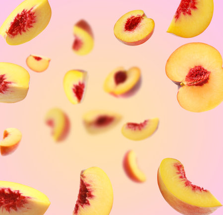 Fresh peaches whirling in air against color gradient backgroundの写真素材