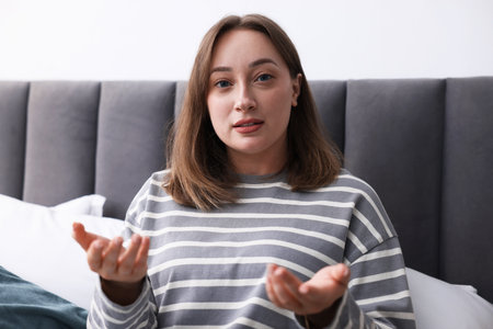 Portrait of woman at home. Online medical consultationの写真素材
