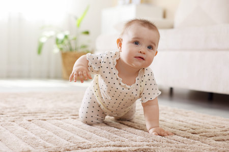 Cute little baby crawling on floor at home