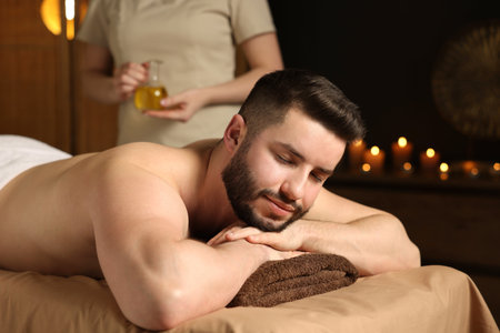 Man receiving relaxing massage in spa salonの写真素材
