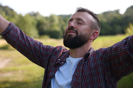 Feeling freedom. Happy man enjoying time outdoors