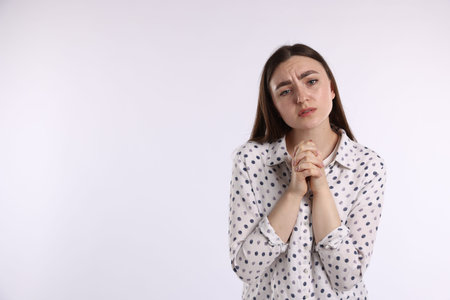 Woman apologizing on white background. Space for text