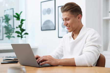 Copywriter using laptop at wooden table indoorsの写真素材