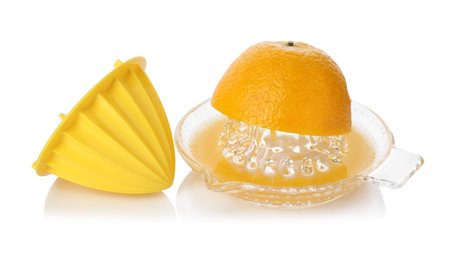Juicer with cut fresh orange isolated white. Making juice