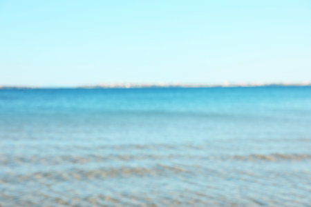 Beautiful sea under light blue sky, blurred view